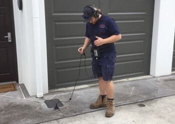 Plumber detecting a leak inside Brisbane home