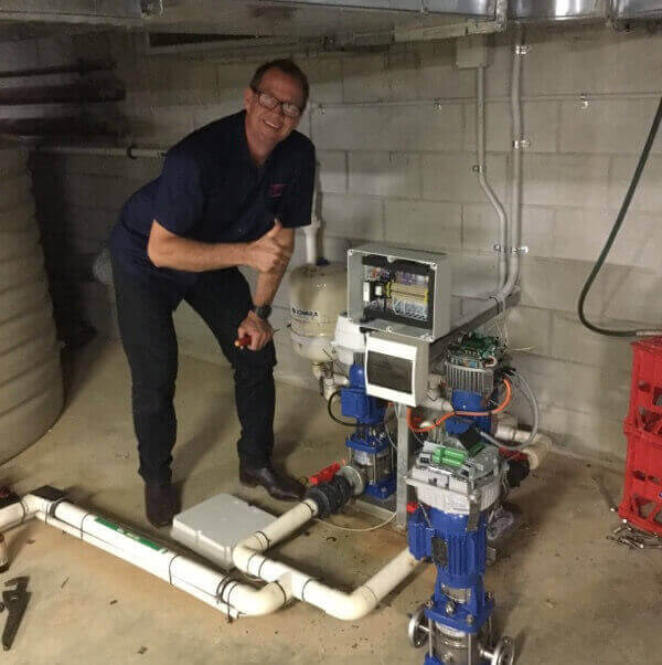 cheap electrician smiling at camera and giving thumbs up after fixing pump connection