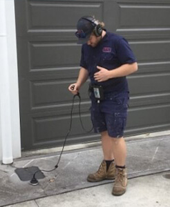 commercial plumber checking plumbing inside large corporate building in Brisbane