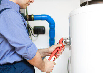 experienced commercial plumbers installing new hot water system and repairing the old one