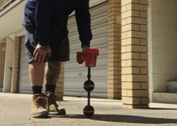 Plumber carrying out leak detection in Brisbane commercial shopping centre