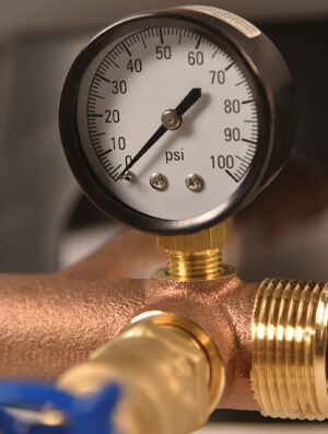plumber checking gas pressure meter in Brisbane