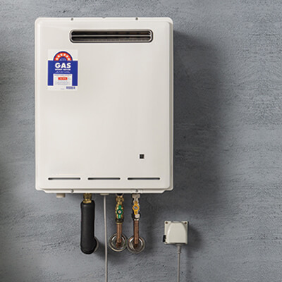 Plumber fixing broken hot water unit in Brisbane