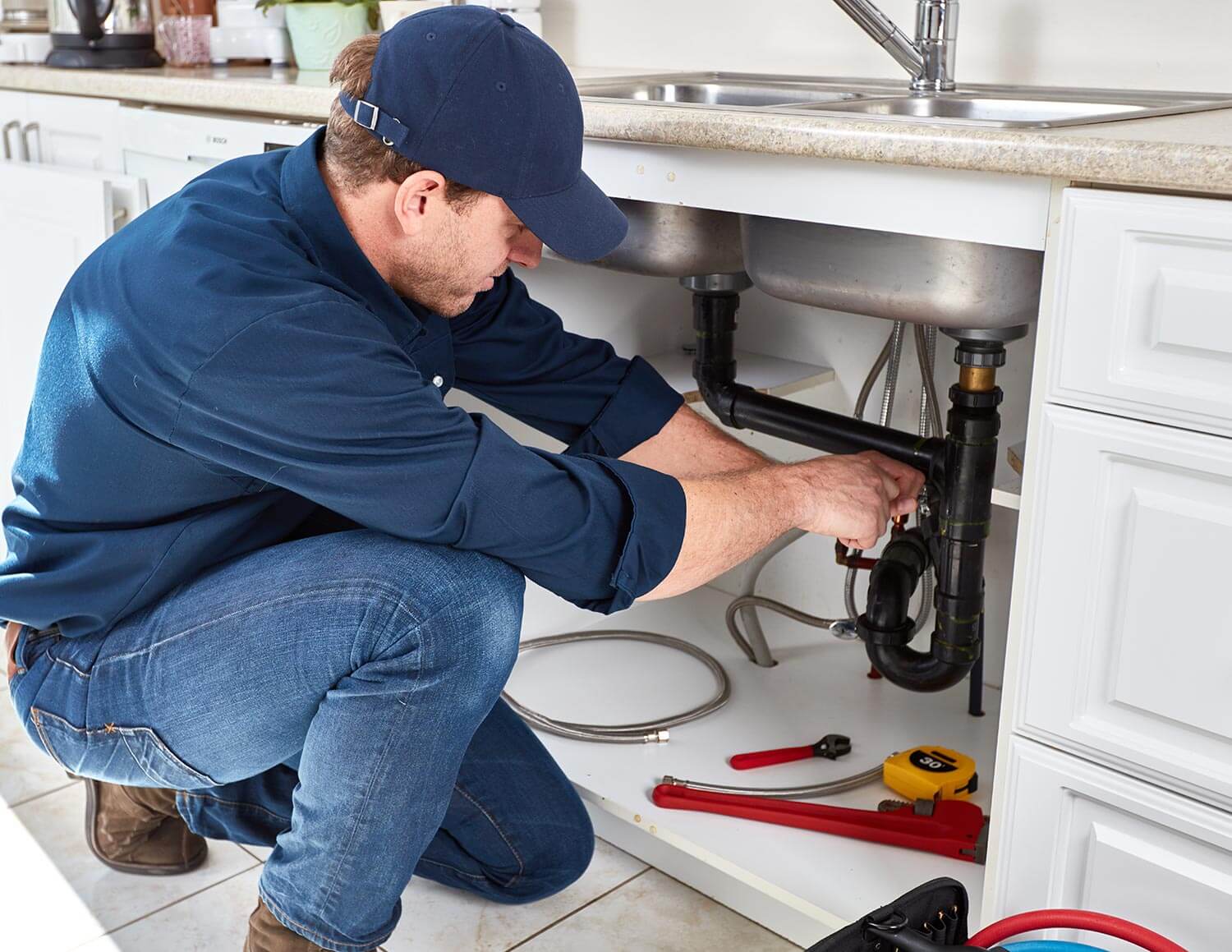 Contact 1 plumber fixing burst pipes under sink inside Brisbane home